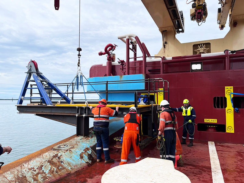 Marine crew aboard a support workboat off the Western Australian coast at sunset