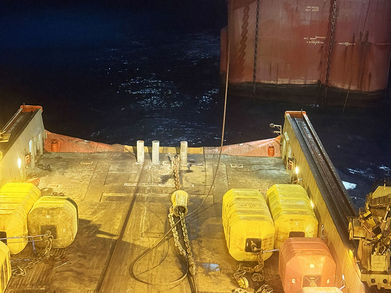 Night operations on a support vessel deck alongside an offshore structure